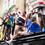 Young black people celebrating Black culture and history through dance, food and music